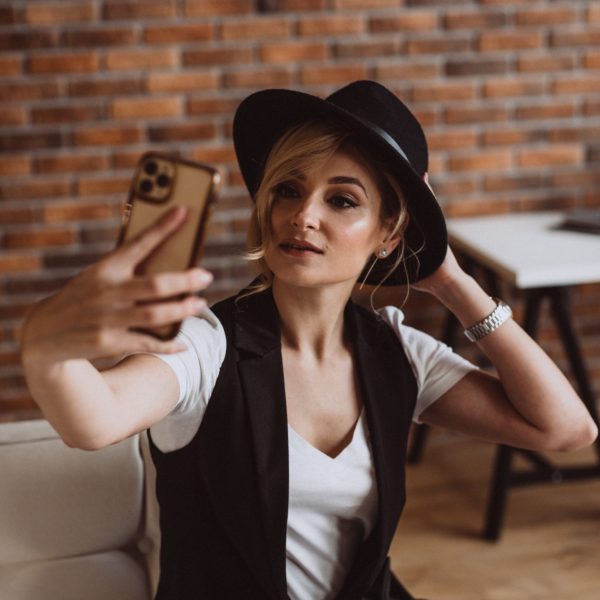 woman in hat makes selfie on smartphone 2022 01 13 21 30 13 utc scaled